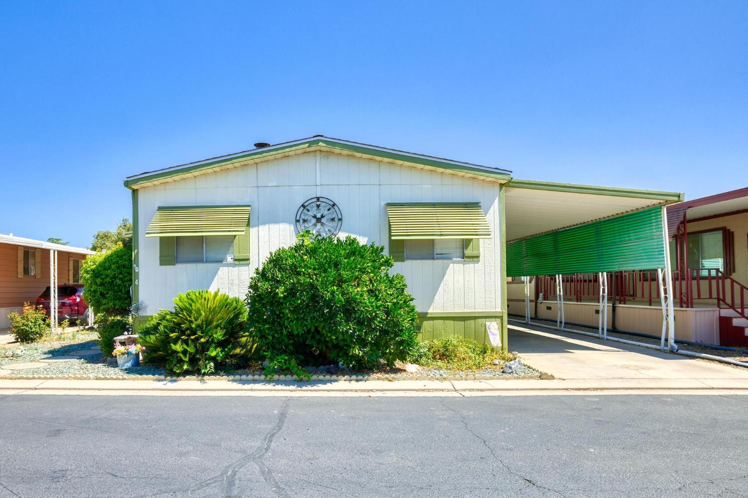 1200 South Carpenter Road, Unit 4 Modesto, CA 95351 - Photo 5 of 31 White-sided residence featuring green trim and awnings