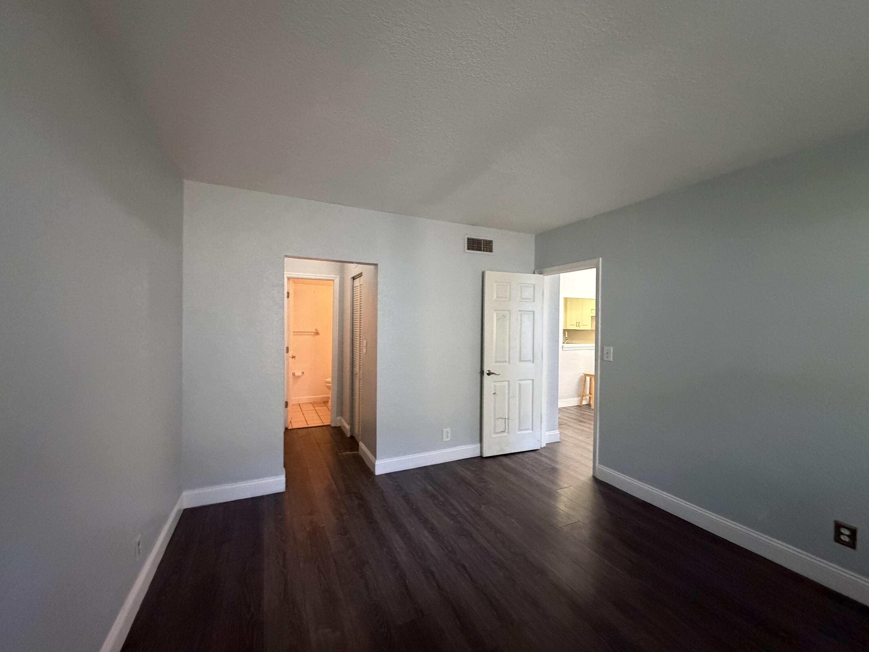 270 South Cypress Road, Unit 204 Pompano Beach, FL 33060 - Photo 8 of 14 a view of an empty room with wooden floor and window