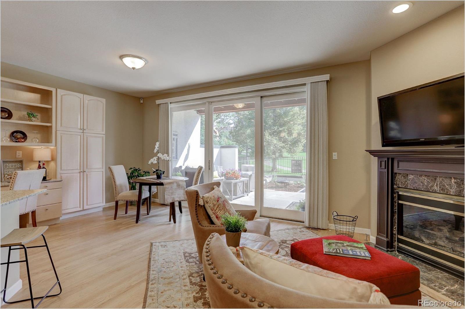 1291 High Street, Unit F Denver, CO 80218 - Photo 11 of 35 a living room with fireplace furniture and a flat screen tv