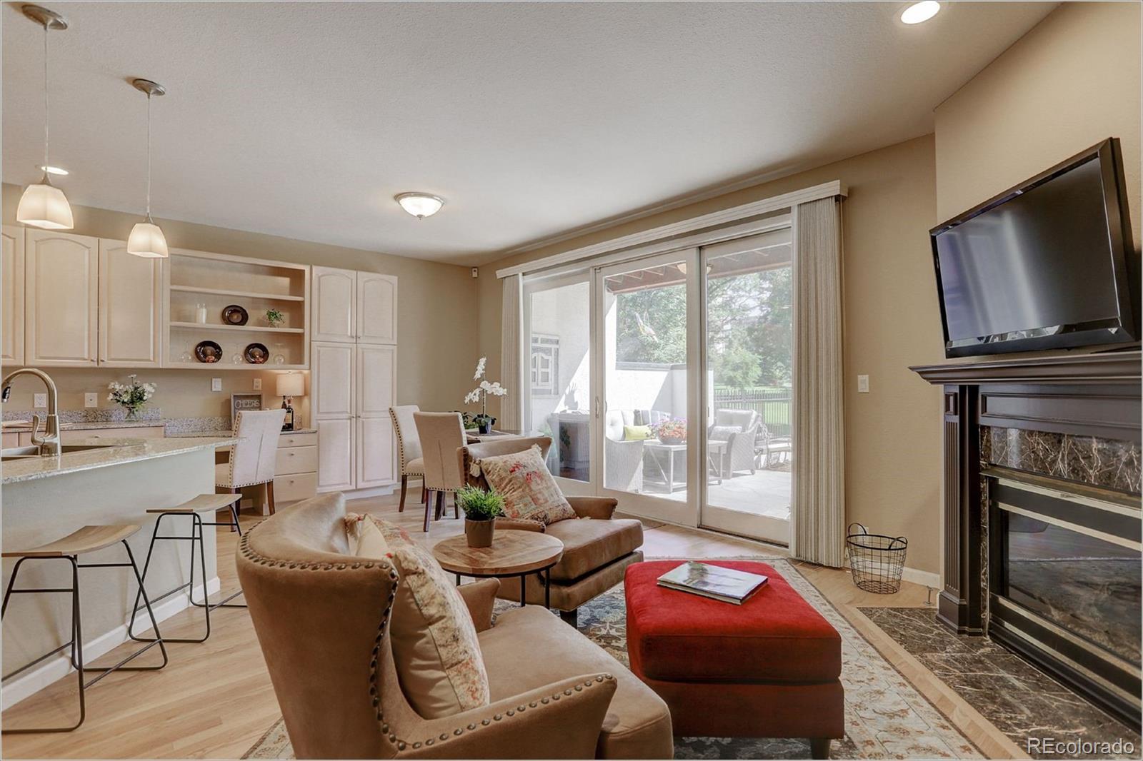 1291 High Street, Unit F Denver, CO 80218 - Photo 16 of 35 a living room with furniture a flat screen tv and floor to ceiling window