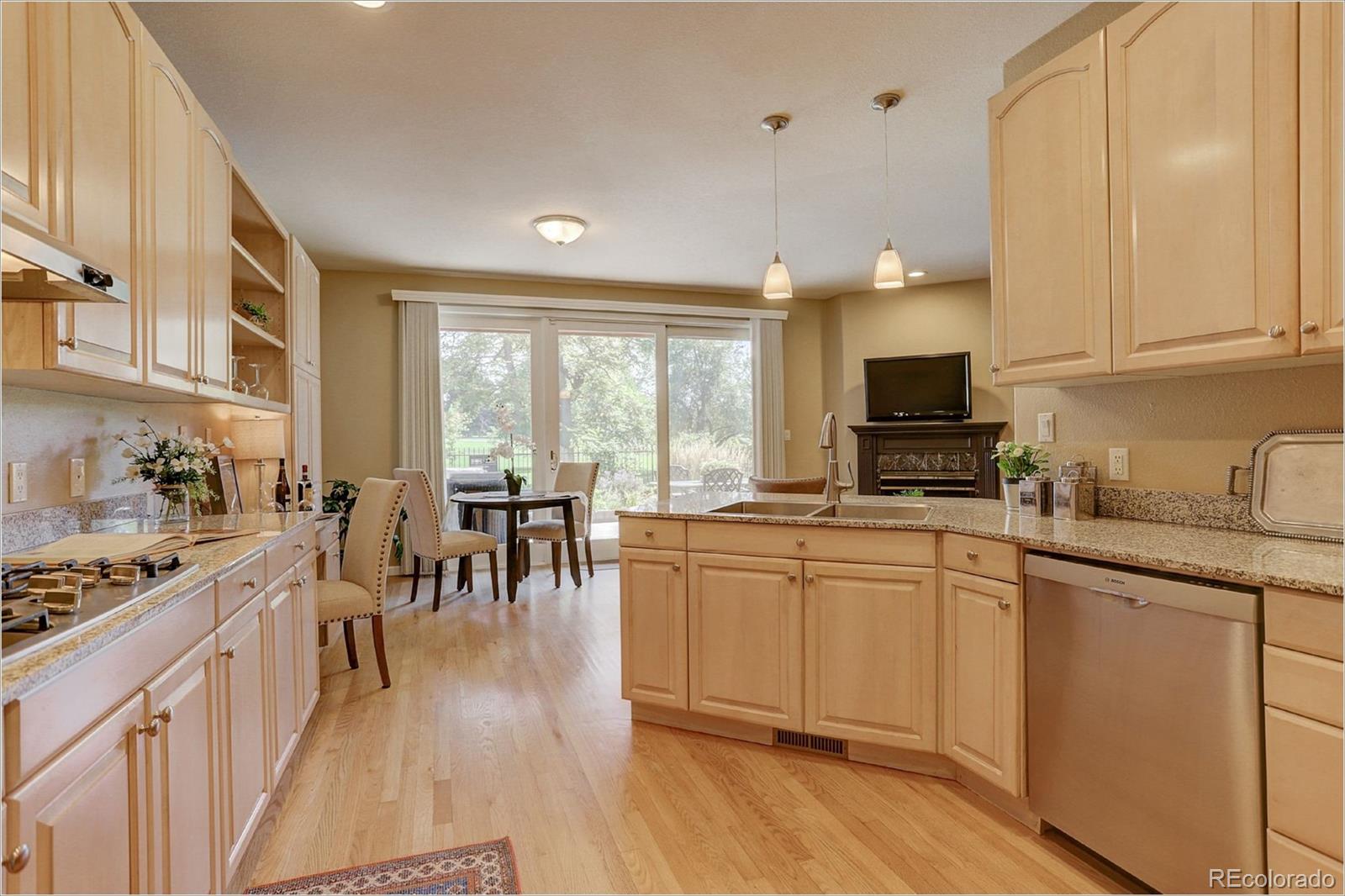 1291 High Street, Unit F Denver, CO 80218 - Photo 17 of 35 a open kitchen with granite countertop a stove top oven a sink a dining table and chairs