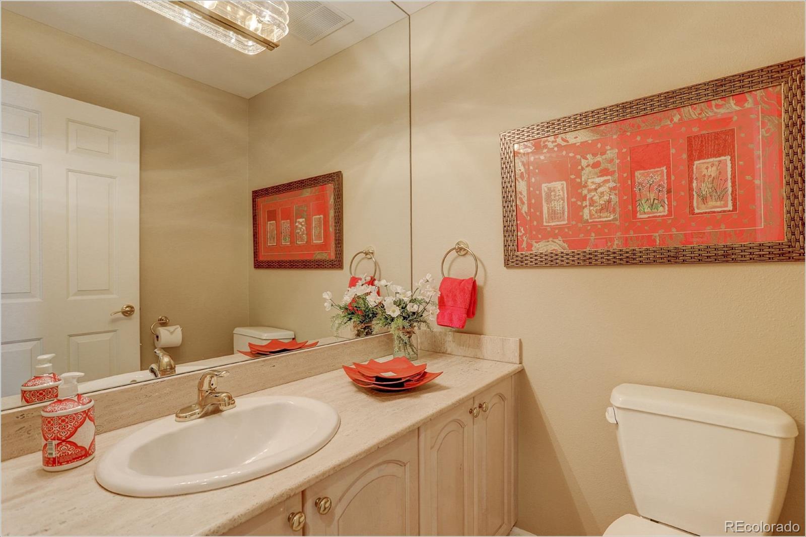 1291 High Street, Unit F Denver, CO 80218 - Photo 28 of 35 a bathroom with a sink a toilet and a mirror