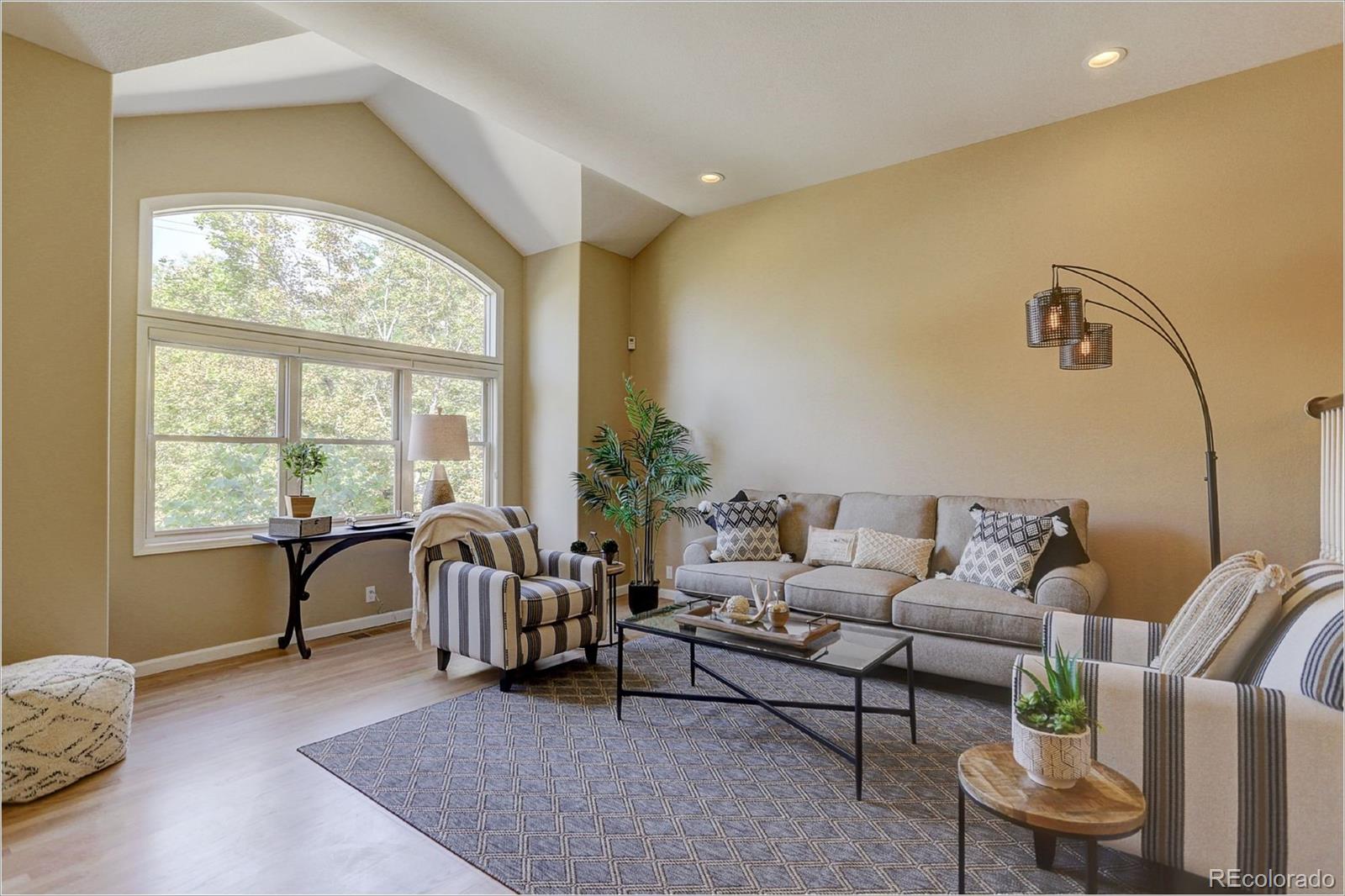 1291 High Street, Unit F Denver, CO 80218 - Photo 5 of 35 a living room with furniture and a large window