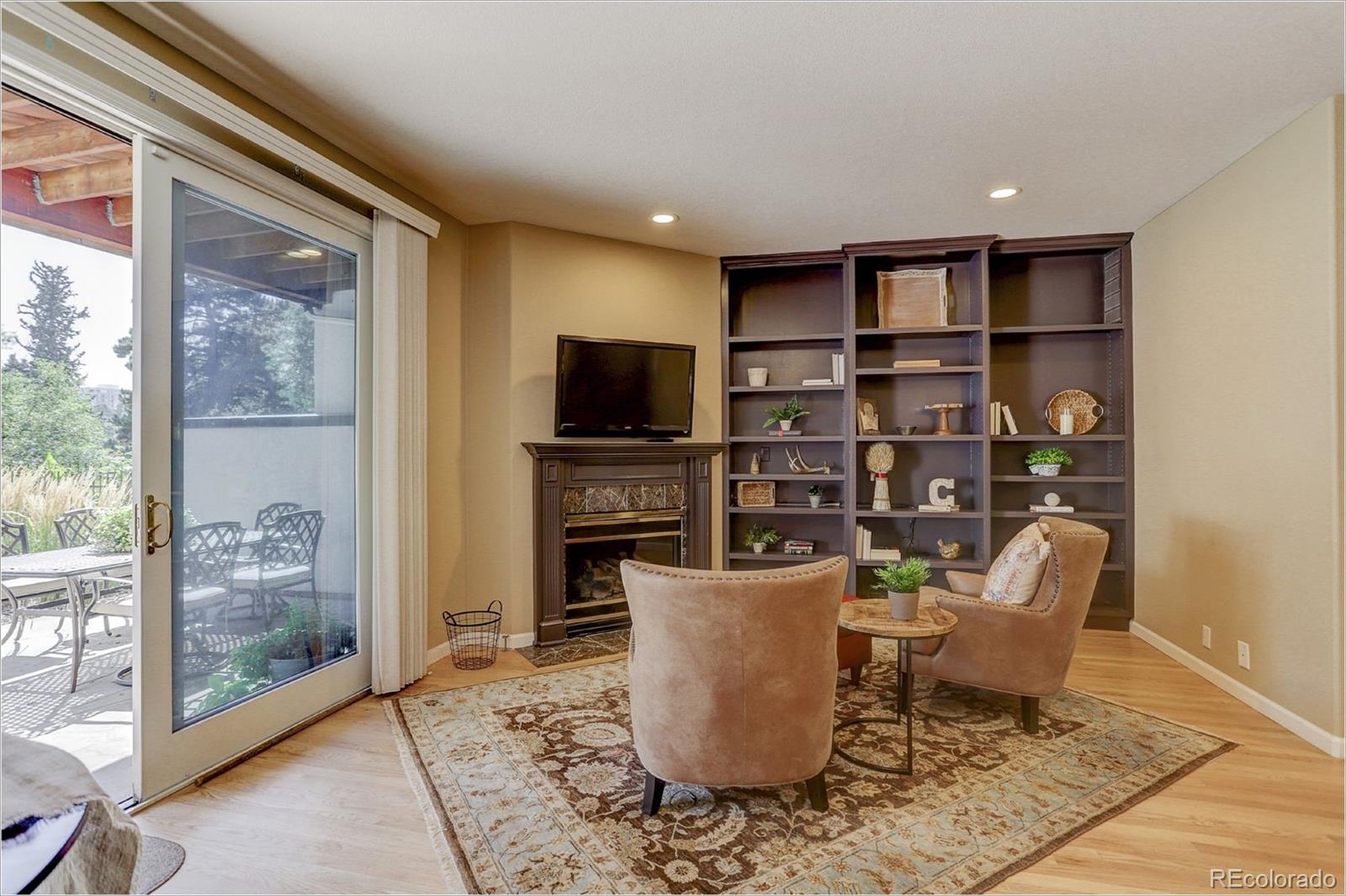 1291 High Street, Unit F Denver, CO 80218 - Photo 10 of 35 a living room with furniture a rug and a floor to ceiling window