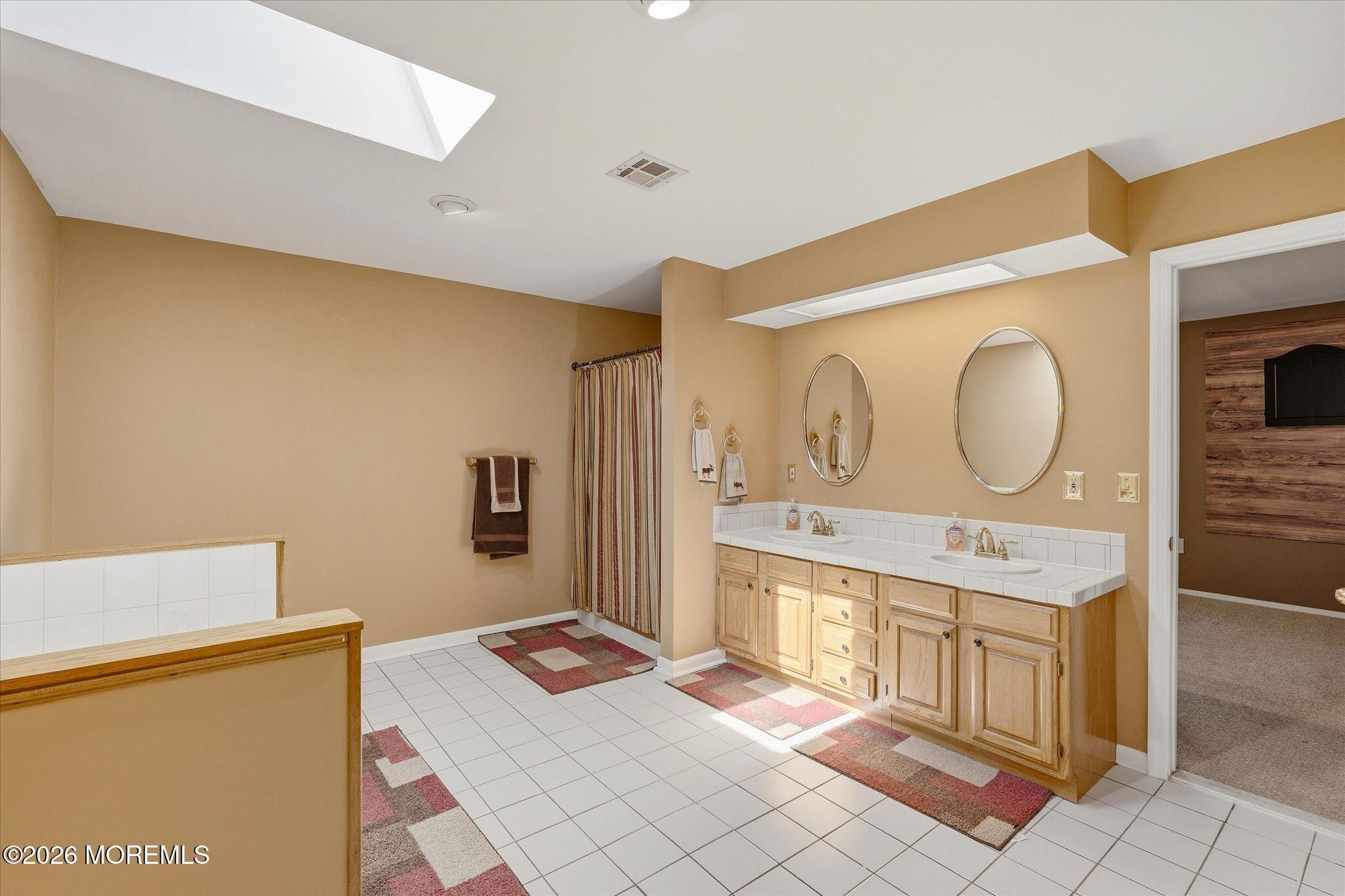 22 Ethan Allen Road Freehold, NJ 07728 - Photo 31 of 31 a spacious bathroom with a mirror sink and a mirror