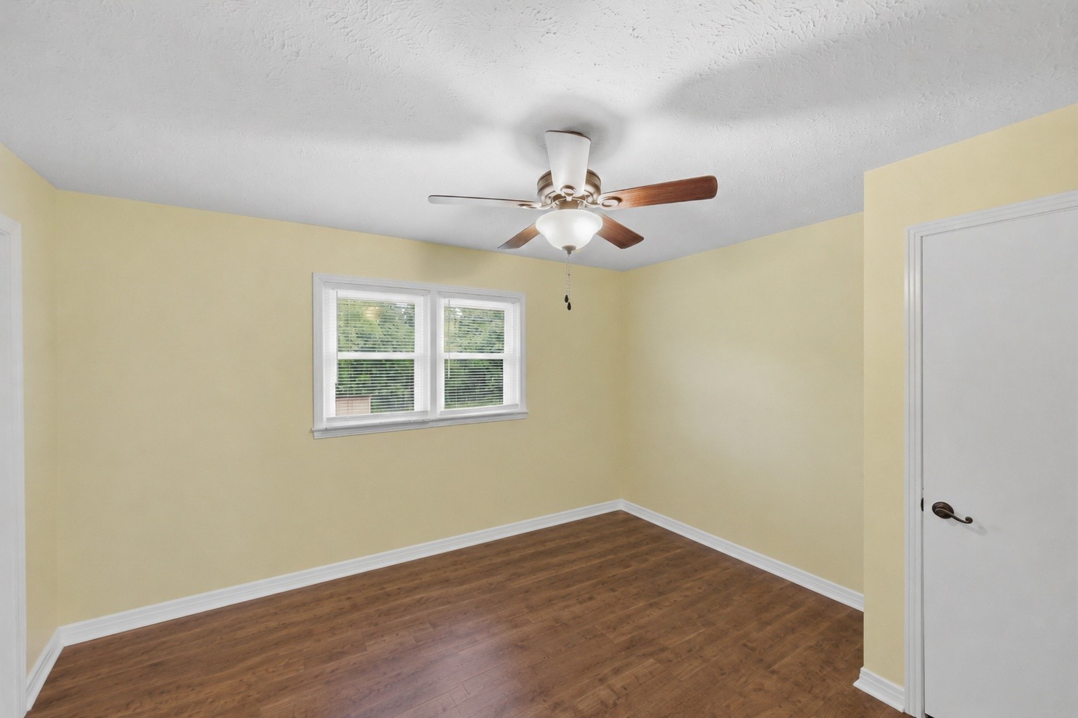 944 Brooksie Thompson Road Decaturville, TN 38329 - Photo 27 of 47 a view of an empty room with wooden floor and a window