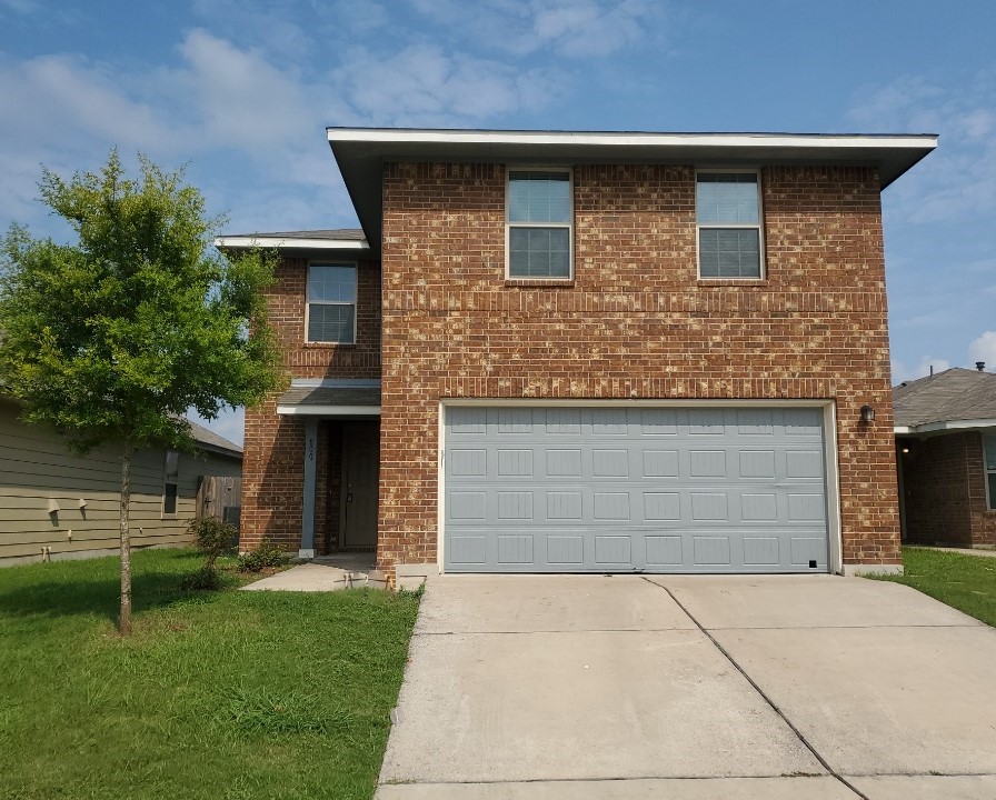 800 Hatton Lane Austin, TX 78725 - Photo 1 of 1 a front view of a house with a yard and garage