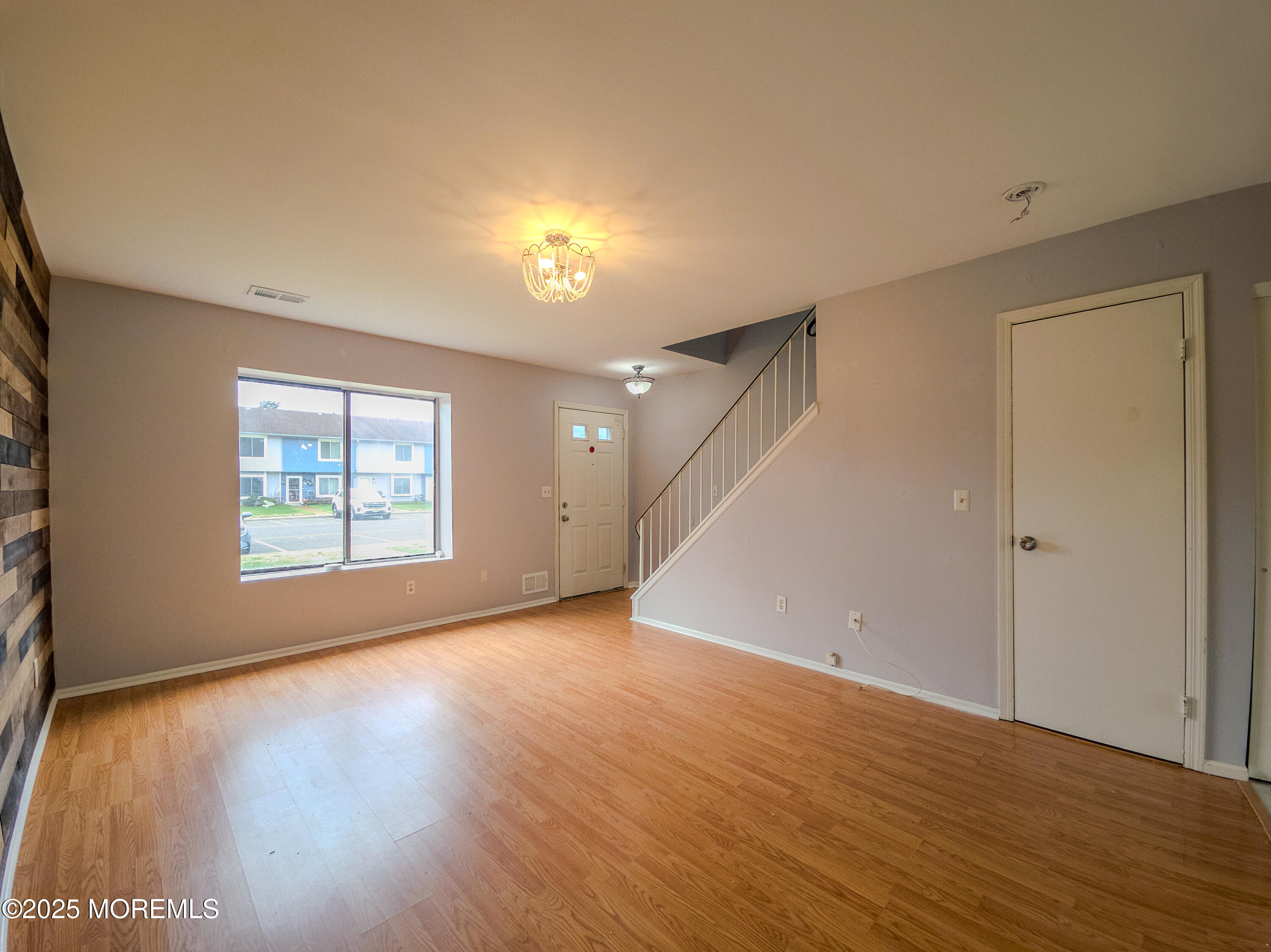 12 Creek Road Brick, NJ 08724 - Photo 2 of 7 a view of an empty room with wooden floor and a window