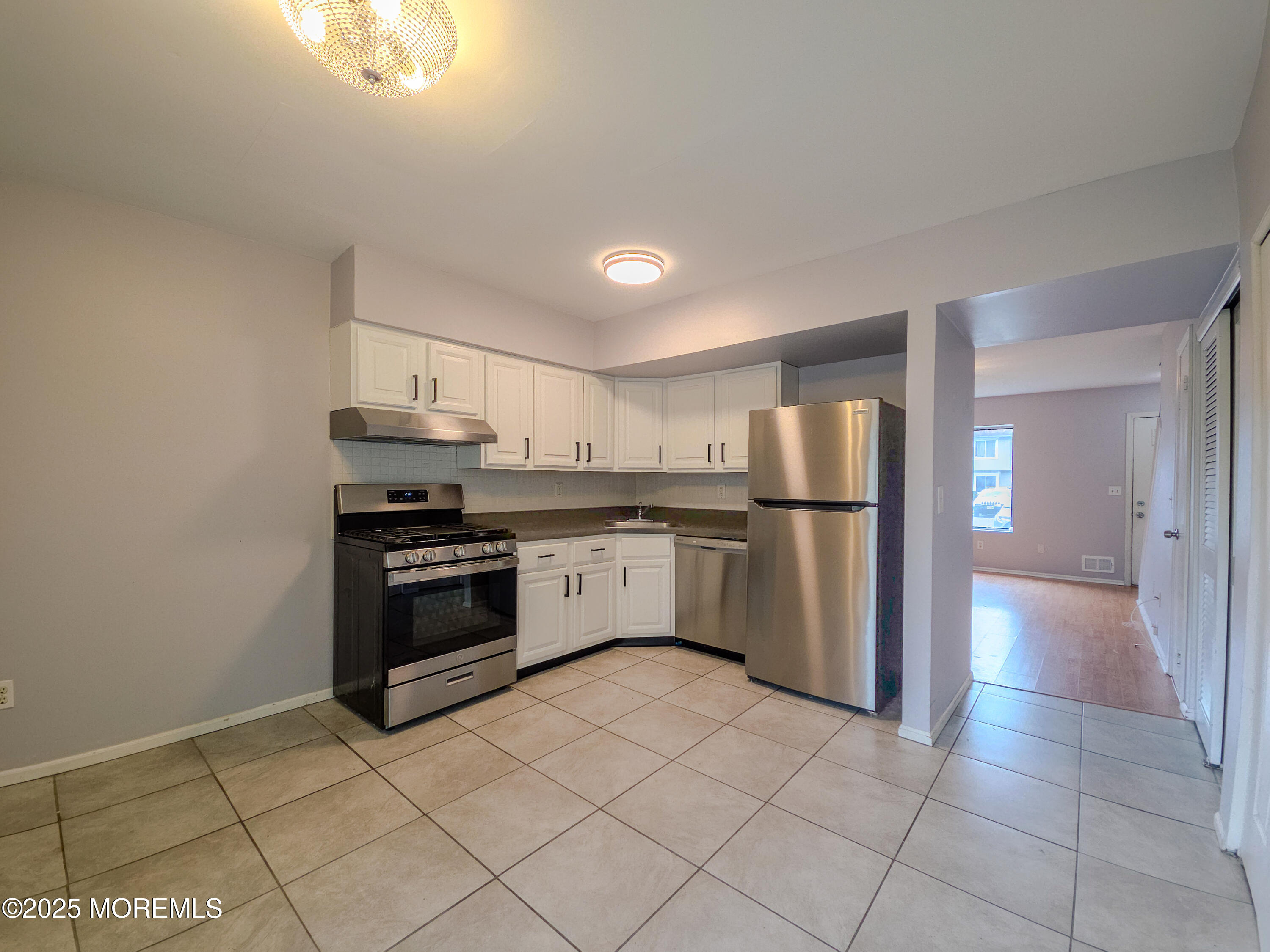 12 Creek Road Brick, NJ 08724 - Photo 3 of 7 a kitchen with stainless steel appliances a refrigerator sink and cabinets