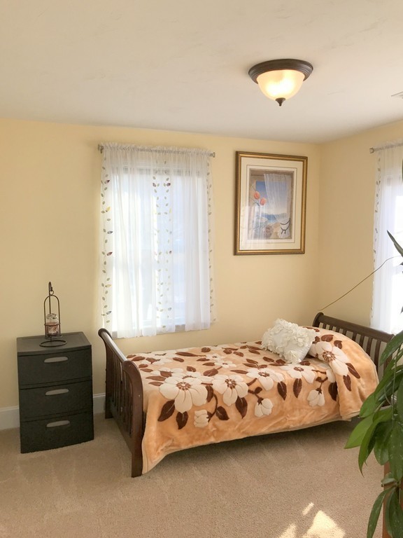 343 Quarry Street, Unit 2 Quincy, MA 02169 - Photo 11 of 30 a bedroom with a bed and a dresser