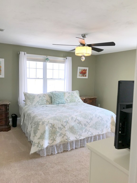 343 Quarry Street, Unit 2 Quincy, MA 02169 - Photo 17 of 30 a bedroom with a bed and a chandelier