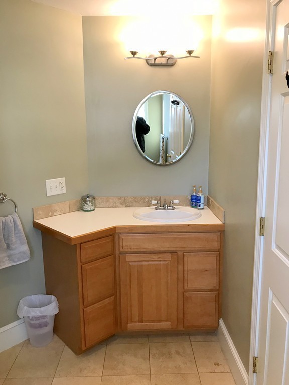 343 Quarry Street, Unit 2 Quincy, MA 02169 - Photo 21 of 30 a bathroom with a sink mirror and toilet