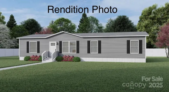 a front view of a house with a garden and yard