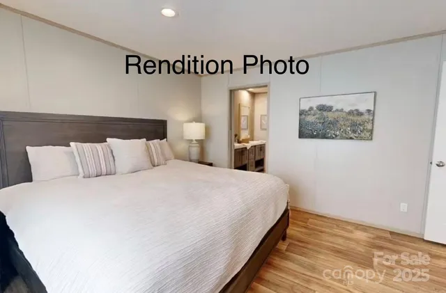 a bedroom with a bed and painting on the wall