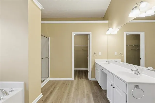 a bathroom with a double vanity sink and mirror with shower