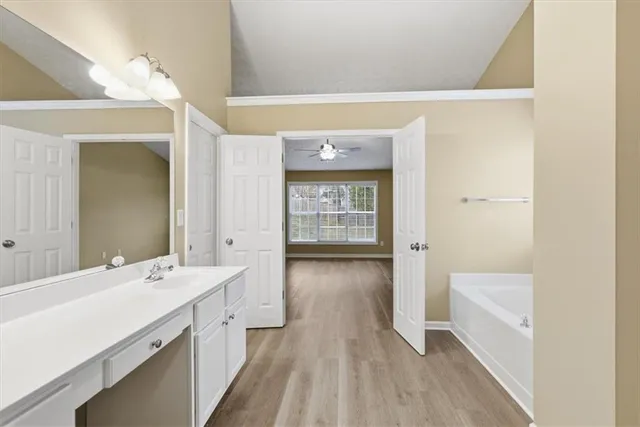 a bathroom with a sink a mirror and a bathtub