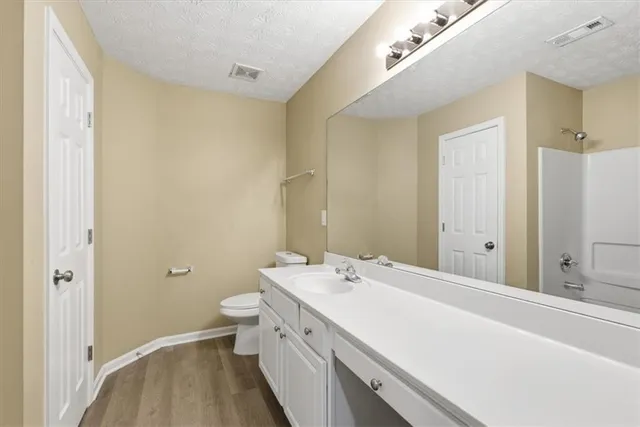 a view of a bathroom with a sink a toilet and a shower