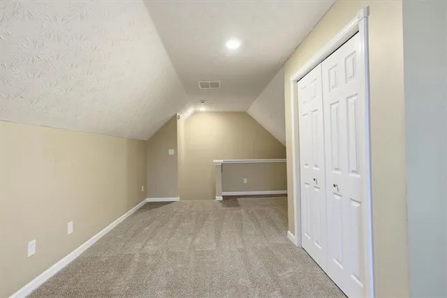 an empty room with entrance and windows