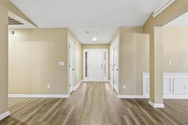 a view of hallway with wooden floor