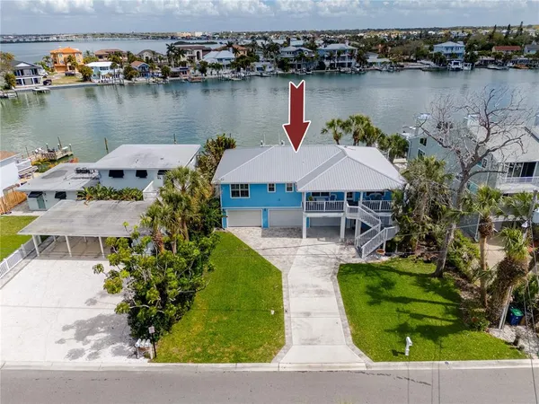 an aerial view of a house with a lake view