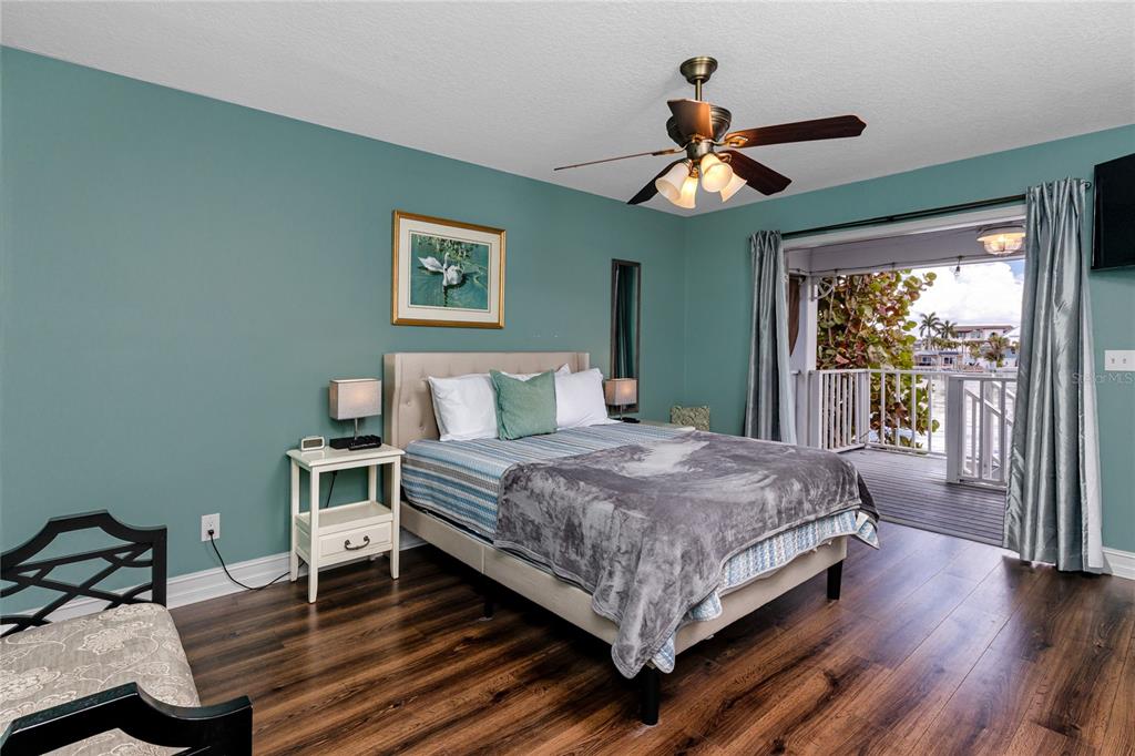 2601 Bay Boulevard Indian Rocks Beach, FL 33785 - Photo 19 of 64 a bedroom with a bed and a chandelier