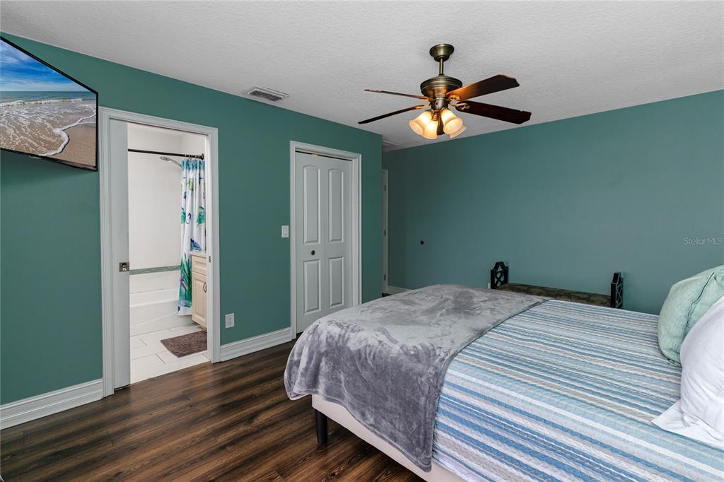 2601 Bay Boulevard Indian Rocks Beach, FL 33785 - Photo 20 of 64 a bedroom with a bed and a chandelier