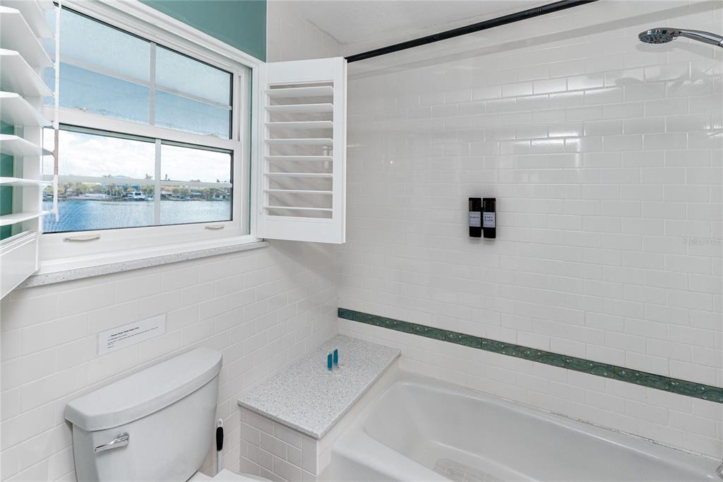 2601 Bay Boulevard Indian Rocks Beach, FL 33785 - Photo 23 of 64 a bathroom with a bathtub and a window