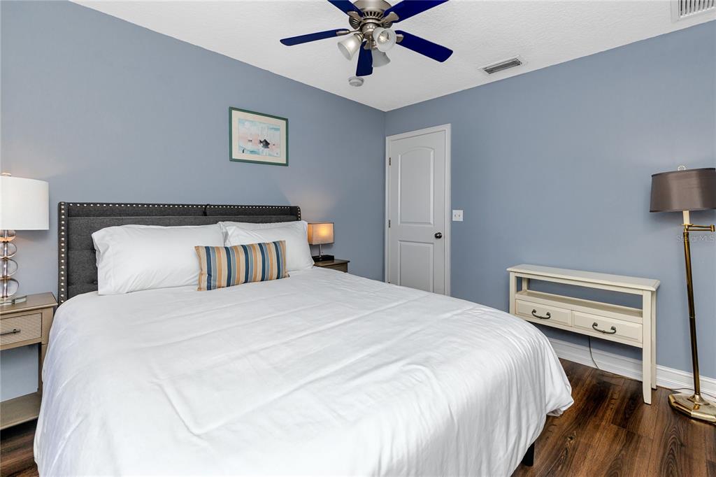2601 Bay Boulevard Indian Rocks Beach, FL 33785 - Photo 29 of 64 a bedroom with a bed and a ceiling fan