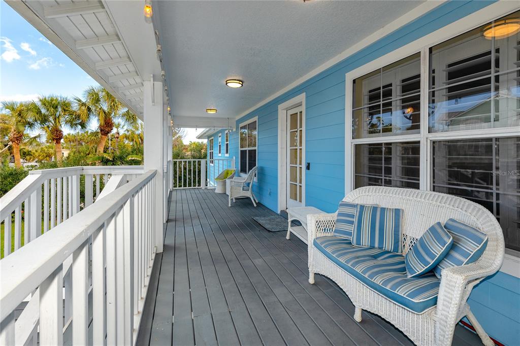 2601 Bay Boulevard Indian Rocks Beach, FL 33785 - Photo 41 of 64 a view of balcony with wooden floor and outdoor seating