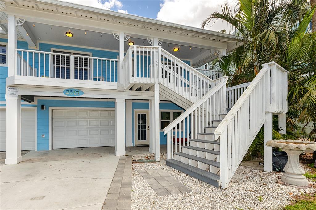 2601 Bay Boulevard Indian Rocks Beach, FL 33785 - Photo 44 of 64 a view of a house with wooden stairs and a small yard