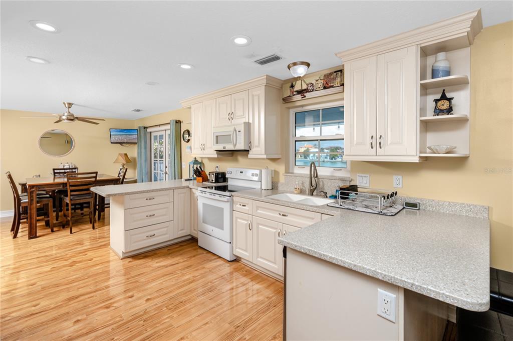 2601 Bay Boulevard Indian Rocks Beach, FL 33785 - Photo 6 of 64 a kitchen with a sink stove and cabinets