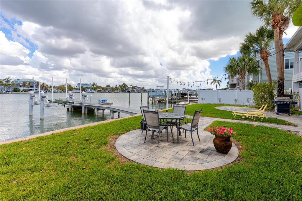 2601 Bay Boulevard Indian Rocks Beach, FL 33785 - Photo 62 of 64 a view of a swimming pool with a table and chairs