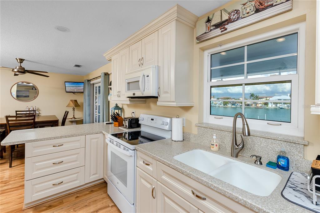 2601 Bay Boulevard Indian Rocks Beach, FL 33785 - Photo 9 of 64 a kitchen with a sink a stove and cabinets