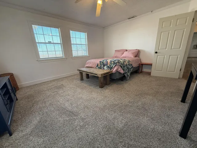 a bed room with a bed and a window