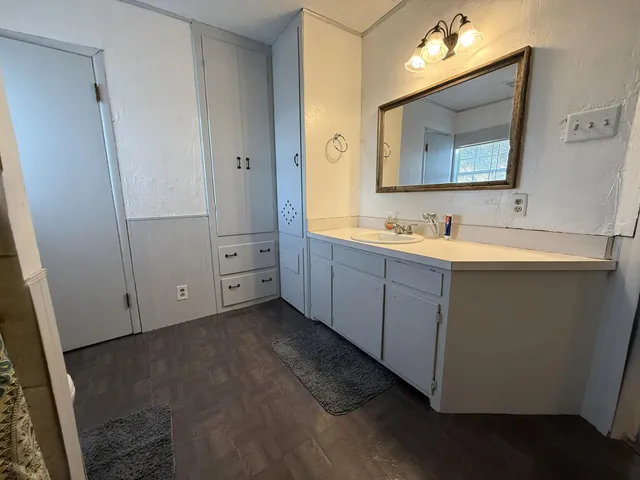 a bathroom with a double vanity sink and mirror