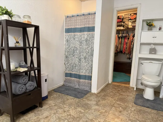 a bathroom with a toilet and a shower