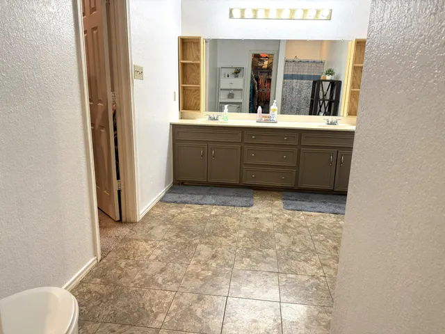 a view of a bathroom with mirror and window