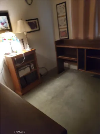 a view of a room with furniture and a window