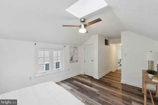 a view of a livingroom with wooden floor and staircase