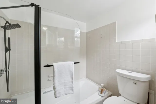 a bathroom with a toilet and a shower