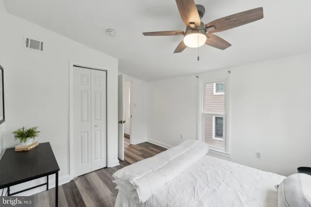 a bedroom with a bed and a potted plant