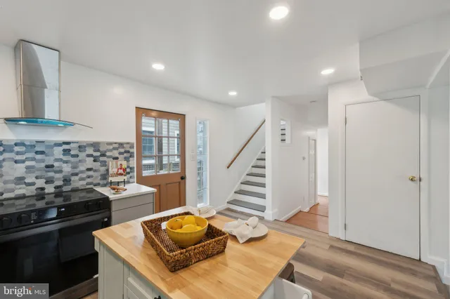a kitchen with stainless steel appliances granite countertop a stove and a sink