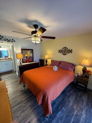 3290 Southeast Aster Lane, Unit D259 Stuart, FL 34994 - Photo 11 of 16 a bedroom with a bed and a chandelier
