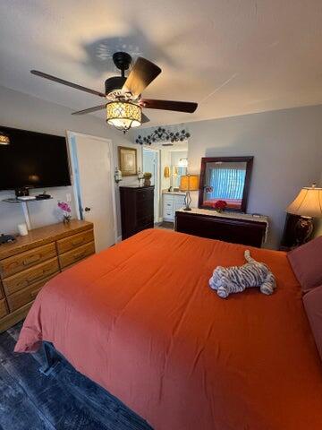 3290 Southeast Aster Lane, Unit D259 Stuart, FL 34994 - Photo 12 of 16 a bedroom with a bed and a flat screen tv