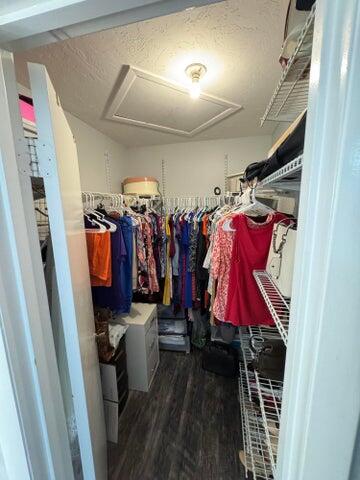 3290 Southeast Aster Lane, Unit D259 Stuart, FL 34994 - Photo 14 of 16 a view of walk in closet with clothes and shoes
