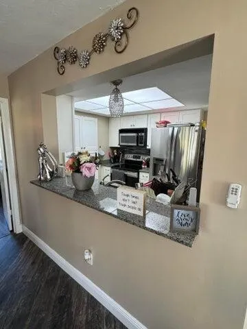 a kitchen counter with a sink and a granite counter top
