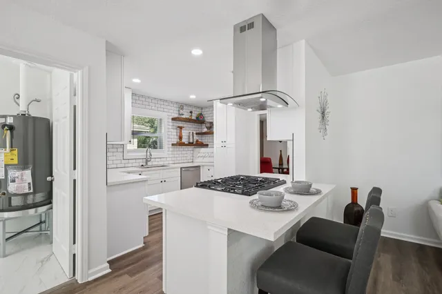 a kitchen with a table and chairs