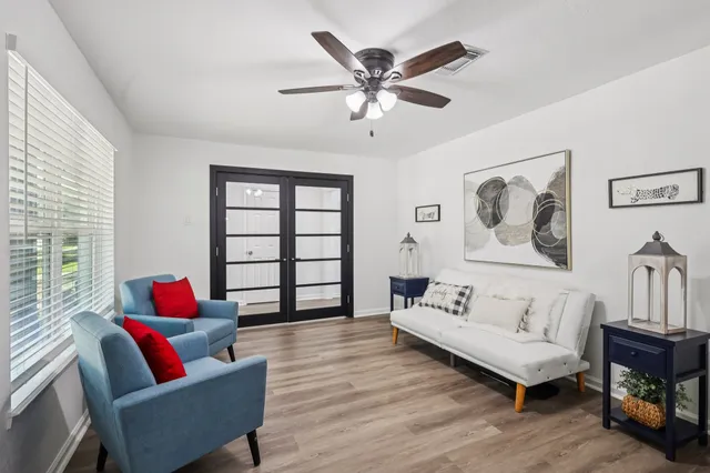 a living room with furniture and a large window