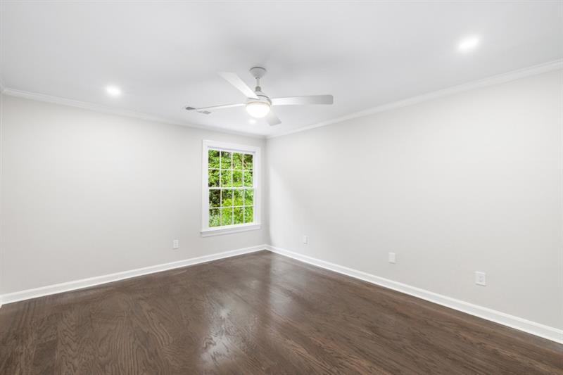 11 Mooregate Square Northwest Atlanta, GA 30327 - Photo 23 of 31 an empty room with wooden floor and windows