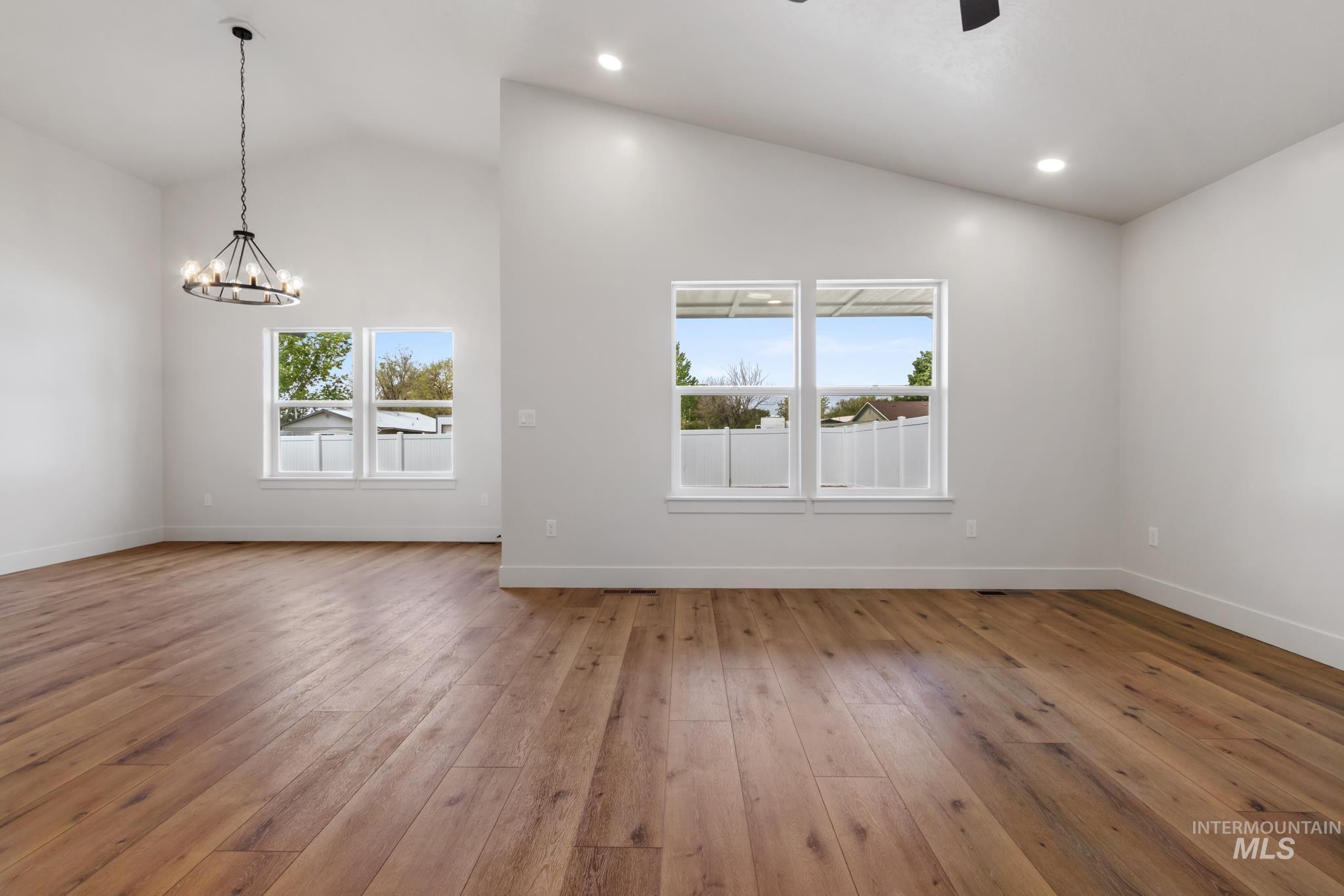 321 North 11th Street Parma, ID 83660 - Photo 12 of 36 Spacious interior featuring wood-finish flooring, vaulted ceilings, and recessed lighting
